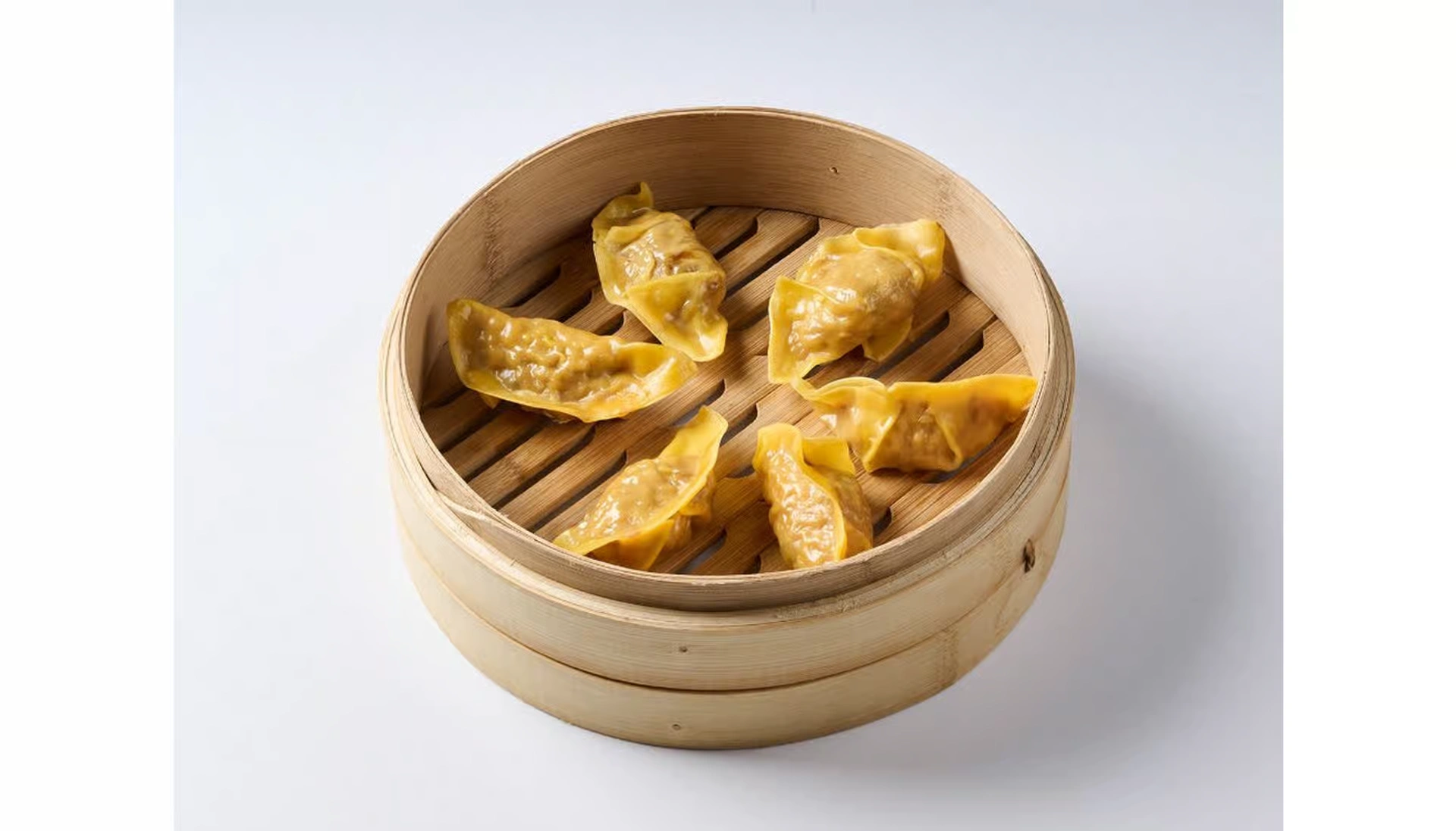Ugly Dumpling chicken dumplings in a bamboo steamer basket